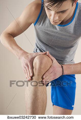 "Young man examining his knee, Mannheim, Baden-Wurttemberg, Germany, Europe" View Large Photo Image Stock Image - "Young man examining his knee, Mannheim, Baden-Wurttemberg, Germany, Europe". Fotosearch