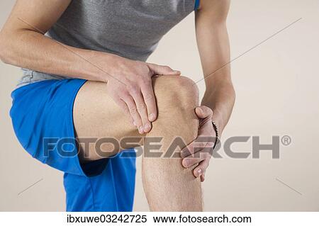 "Young man examining his knee, Mannheim, Baden-Wurttemberg, Germany, Europe" View Large Photo Image Stock Photography - "Young man examining his knee, Mannheim, Baden-Wurttemberg, Germany, Europe". Fotosearch