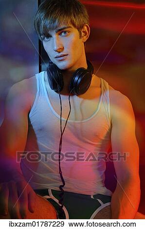 Young man in underwear with headphones in colorful light View Large Photo Image Stock Photo - Young man in underwear with headphones in colorful light. Fotosearch