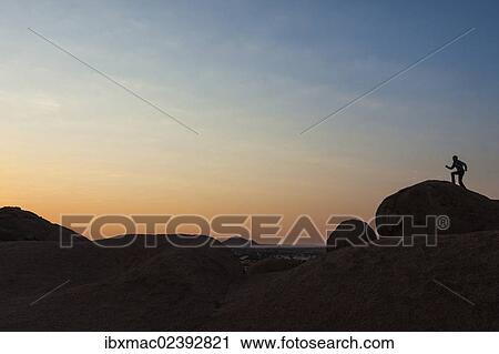 "Young man jumping, granite rocks, near Spitzkoppe granite peaks, Damaraland, Namibia, Africa" View Large Photo Image Stock Image - "Young man jumping, granite rocks, near Spitzkoppe granite peaks, Damaraland, Namibia, Africa". Fotosearch