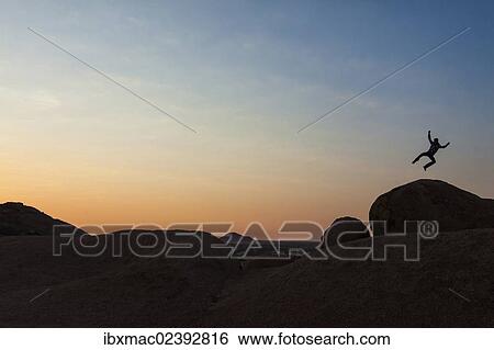 "Young man jumping, granite rocks, near Spitzkoppe granite peaks, Damaraland, Namibia, Africa" View Large Photo Image Stock Photograph - "Young man jumping, granite rocks, near Spitzkoppe granite peaks, Damaraland, Namibia, Africa". Fotosearch