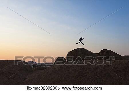 "Young man jumping, granite rocks, near Spitzkoppe granite peaks, Damaraland, Namibia, Africa" View Large Photo Image Stock Photography - "Young man jumping, granite rocks, near Spitzkoppe granite peaks, Damaraland, Namibia, Africa". Fotosearch