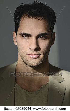 Picture - "Young man lit by sunlight, portrait". Fotosearch