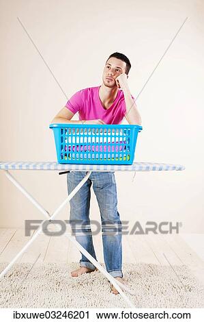 "Young man looking desperate while leaning on an ironing board, Mannheim, Baden-Wurttemberg, Germany, Europe" View Large Photo Image Stock Image - "Young man looking desperate while leaning on an ironing board, Mannheim, Baden-Wurttemberg, Germany, Europe". Fotosearch