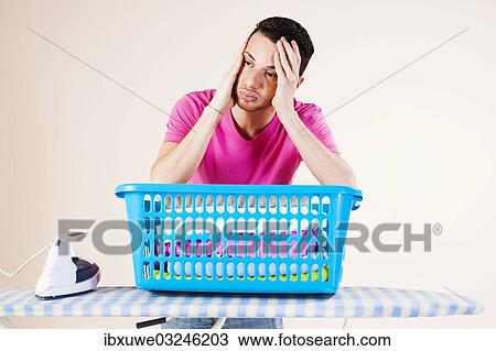 "Young man looking desperate while leaning on an ironing board, Mannheim, Baden-Wurttemberg, Germany, Europe" View Large Photo Image Stock Image - "Young man looking desperate while leaning on an ironing board, Mannheim, Baden-Wurttemberg, Germany, Europe". Fotosearch