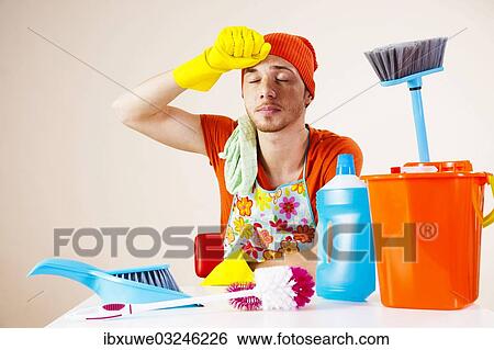 "Young man looking exhausted after doing the the cleaning, Mannheim, Baden-Wurttemberg, Germany, Europe" View Large Photo Image Stock Photograph - "Young man looking exhausted after doing the the cleaning, Mannheim, Baden-Wurttemberg, Germany, Europe". Fotosearch