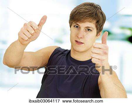 "Young man, muscular, making a thumbs up gesture with both hands" View Large Photo Image Stock Photo - "Young man, muscular, making a thumbs up gesture with both hands". Fotosearch