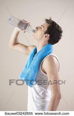 "Young man quenches his thirst with a bottle of water after doing sport, Mannheim, Baden-Wurttemberg, Germany, Europe" View Large Photo Image Stock Photography - "Young man quenches his thirst with a bottle of water after doing sport, Mannheim, Baden-Wurttemberg, Germany, Europe". Fotosearch