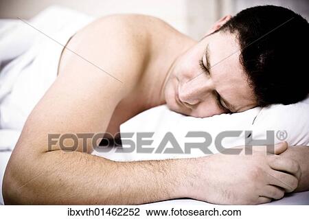 Young man sleeping in bed View Large Photo Image Stock Image - Young man sleeping in bed. Fotosearch