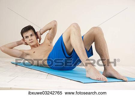 "Young man training his stomach muscles, Mannheim, Baden-Wurttemberg, Germany, Europe" View Large Photo Image Stock Photography - "Young man training his stomach muscles, Mannheim, Baden-Wurttemberg, Germany, Europe". Fotosearch