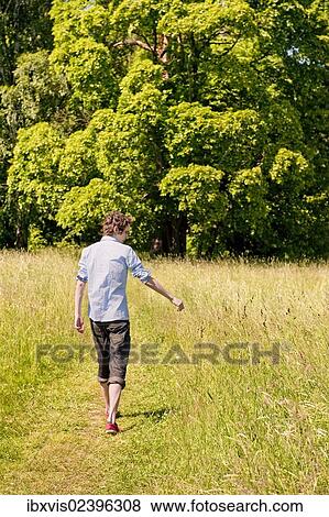 "Young man walking in nature, Sweden, Europe" View Large Photo Image Stock Photo - "Young man walking in nature, Sweden, Europe". Fotosearch