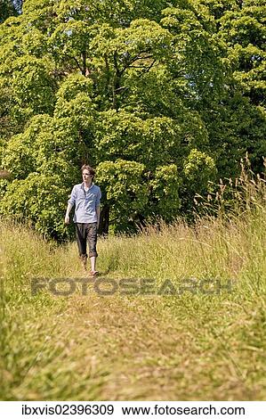 "Young man walking in nature, Sweden, Europe" View Large Photo Image Stock Photo - "Young man walking in nature, Sweden, Europe". Fotosearch