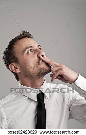 Stock Photo - "Young man wearing a shirt and a tie, kissing his fingers, success, victory pose". Fotosearch