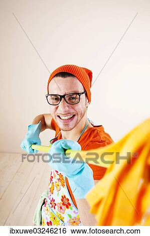 "Young man wearing an apron and cleaning gloves holding a cleaning mop, Mannheim, Baden-Wurttemberg, Germany, Europe" View Large Photo Image Stock Photograph - "Young man wearing an apron and cleaning gloves holding a cleaning mop, Mannheim, Baden-Wurttemberg, Germany, Europe". Fotosearch