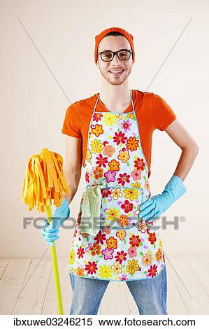 "Young man wearing an apron and cleaning gloves holding a cleaning mop, Mannheim, Baden-Wurttemberg, Germany, Europe" View Large Photo Image Stock Photography - "Young man wearing an apron and cleaning gloves holding a cleaning mop, Mannheim, Baden-Wurttemberg, Germany, Europe". Fotosearch