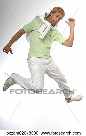 Stock Image - "Young man wearing casual summer clothes, jumping in the air for joy". Fotosearch