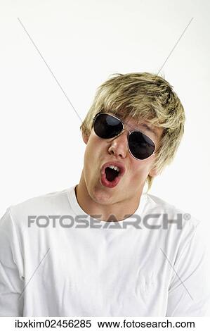 Young man wearing sunglasses View Large Photo Image Stock Photography - Young man wearing sunglasses. Fotosearch