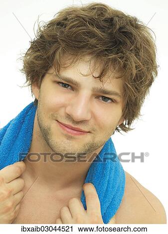 "Young man with a blue towel wrapped around his shoulders, portrait" View Large Photo Image Stock Image - "Young man with a blue towel wrapped around his shoulders, portrait". Fotosearch
