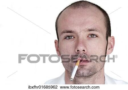 Stock Image - Young man with a cigarette in his mouth. Fotosearch