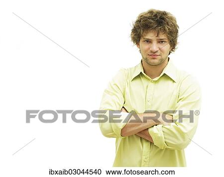 Stock Image - Young man with his arms crossed. Fotosearch