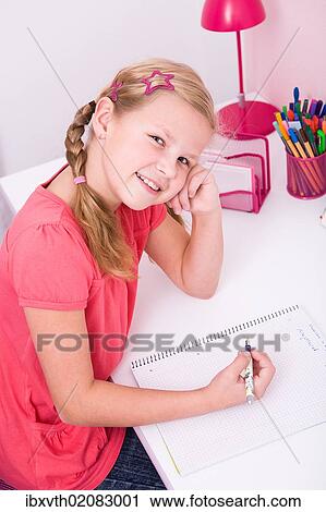 Young schoolgirl doing her homework at her desk View Large Photo Image Stock Image - Young schoolgirl doing her homework at her desk. Fotosearch