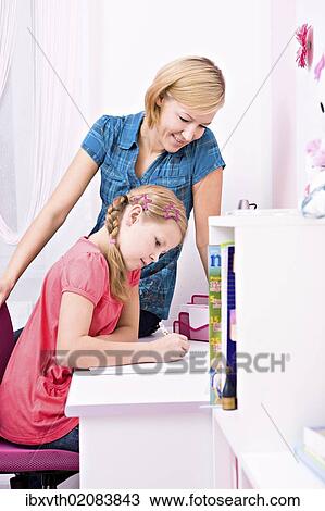 "Young schoolgirl sitting at desk, doing her homework" View Large Photo Image Stock Image - "Young schoolgirl sitting at desk, doing her homework". Fotosearch