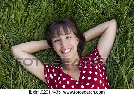 "Young woman, 25, lying in a meadow" View Large Photo Image Stock Photography - "Young woman, 25, lying in a meadow". Fotosearch