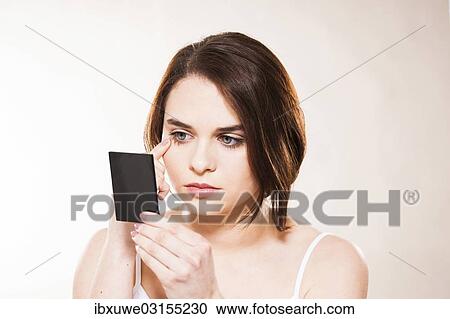 "Young woman applying make-up, Mannheim, Baden-Wurttemberg, Germany, Europe" View Large Photo Image Stock Image - "Young woman applying make-up, Mannheim, Baden-Wurttemberg, Germany, Europe". Fotosearch