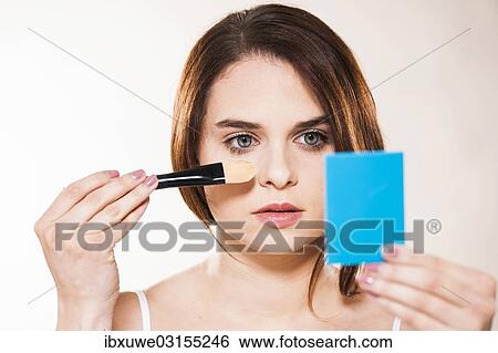 "Young woman applying make-up, Mannheim, Baden-Wurttemberg, Germany, Europe" View Large Photo Image Stock Photograph - "Young woman applying make-up, Mannheim, Baden-Wurttemberg, Germany, Europe". Fotosearch