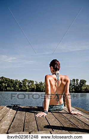 Stock Photo - Young woman at lakeside. Fotosearch