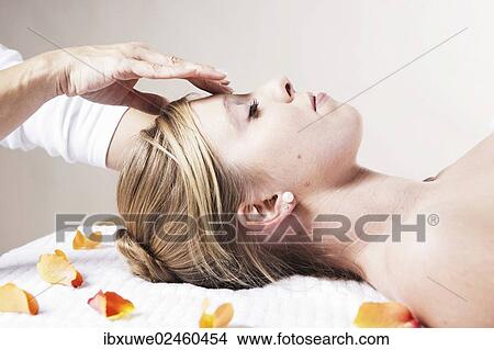 Young woman being treated by a therapist on her head and upper torso View Large Photo Image Picture - Young woman being treated by a therapist on her head and upper torso. Fotosearch
