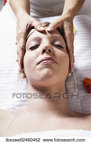 Young woman being treated by a therapist on her head and upper torso View Large Photo Image Stock Image - Young woman being treated by a therapist on her head and upper torso. Fotosearch