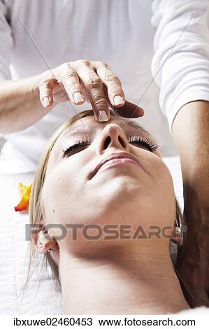 Young woman being treated by a therapist on her head and upper torso View Large Photo Image Stock Image - Young woman being treated by a therapist on her head and upper torso. Fotosearch
