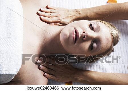 Young woman being treated by a therapist on her head and upper torso View Large Photo Image Stock Photograph - Young woman being treated by a therapist on her head and upper torso. Fotosearch