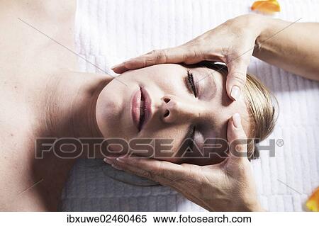 Young woman being treated by a therapist on her head and upper torso View Large Photo Image Stock Photography - Young woman being treated by a therapist on her head and upper torso. Fotosearch