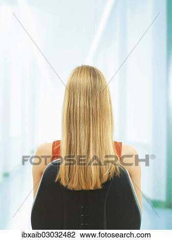 "Young woman, blond, sitting on a chair, rear view" View Large Photo Image Stock Image - "Young woman, blond, sitting on a chair, rear view". Fotosearch