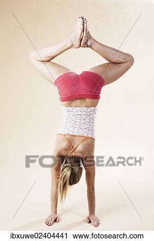 Young woman doing a handstand View Large Photo Image Stock Image - Young woman doing a handstand. Fotosearch
