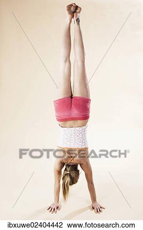 Young woman doing a handstand View Large Photo Image Stock Image - Young woman doing a handstand. Fotosearch