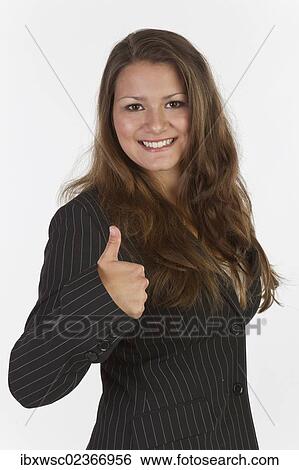 Young woman doing a thumbs up gesture View Large Photo Image Stock Photograph - Young woman doing a thumbs up gesture. Fotosearch