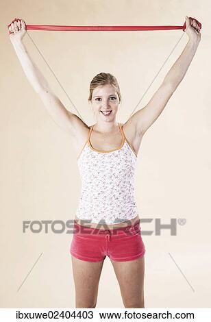Young woman doing exercises with a Theraband View Large Photo Image Stock Image - Young woman doing exercises with a Theraband. Fotosearch
