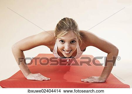 Young woman doing push-ups View Large Photo Image Picture - Young woman doing push-ups. Fotosearch