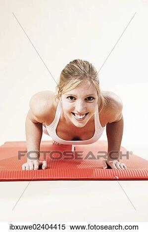 Young woman doing push-ups View Large Photo Image Stock Photography - Young woman doing push-ups. Fotosearch