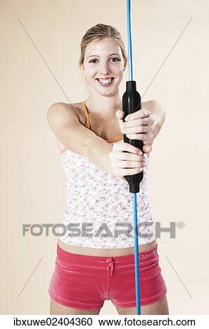 Young woman doing sport exercises with a vibrating rod View Large Photo Image Stock Image - Young woman doing sport exercises with a vibrating rod. Fotosearch