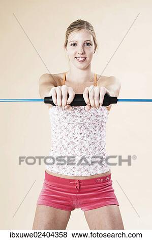 Young woman doing sport exercises with a vibrating rod View Large Photo Image Stock Photo - Young woman doing sport exercises with a vibrating rod. Fotosearch