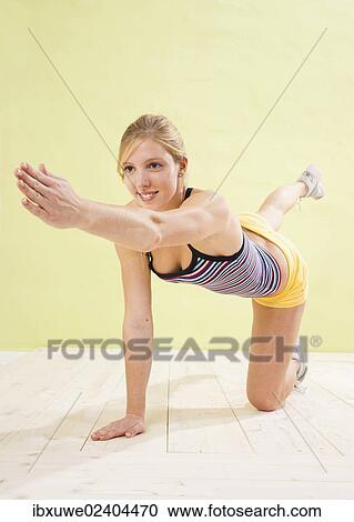 Young woman doing strengthening exercises View Large Photo Image Stock Image - Young woman doing strengthening exercises. Fotosearch