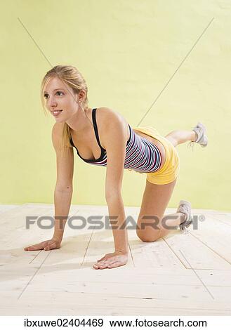 Young woman doing strengthening exercises View Large Photo Image Stock Photo - Young woman doing strengthening exercises. Fotosearch