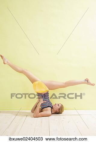 Young woman doing stretching and strengthening exercises View Large Photo Image Stock Image - Young woman doing stretching and strengthening exercises. Fotosearch