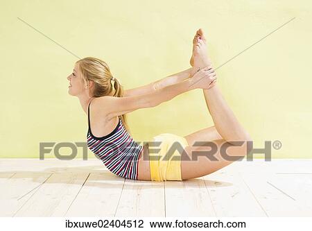Young woman doing stretching and strengthening exercises View Large Photo Image Stock Image - Young woman doing stretching and strengthening exercises. Fotosearch