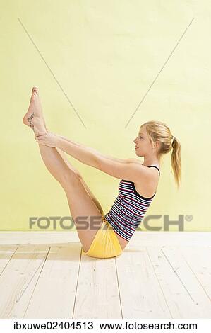 Young woman doing stretching and strengthening exercises View Large Photo Image Stock Image - Young woman doing stretching and strengthening exercises. Fotosearch