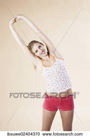 Young woman doing stretching exercises View Large Photo Image Stock Image - Young woman doing stretching exercises. Fotosearch